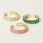Seraphina Treasures adjustable ring with clear, pink, and green cubic zirconia stones on a gold-tone copper band.