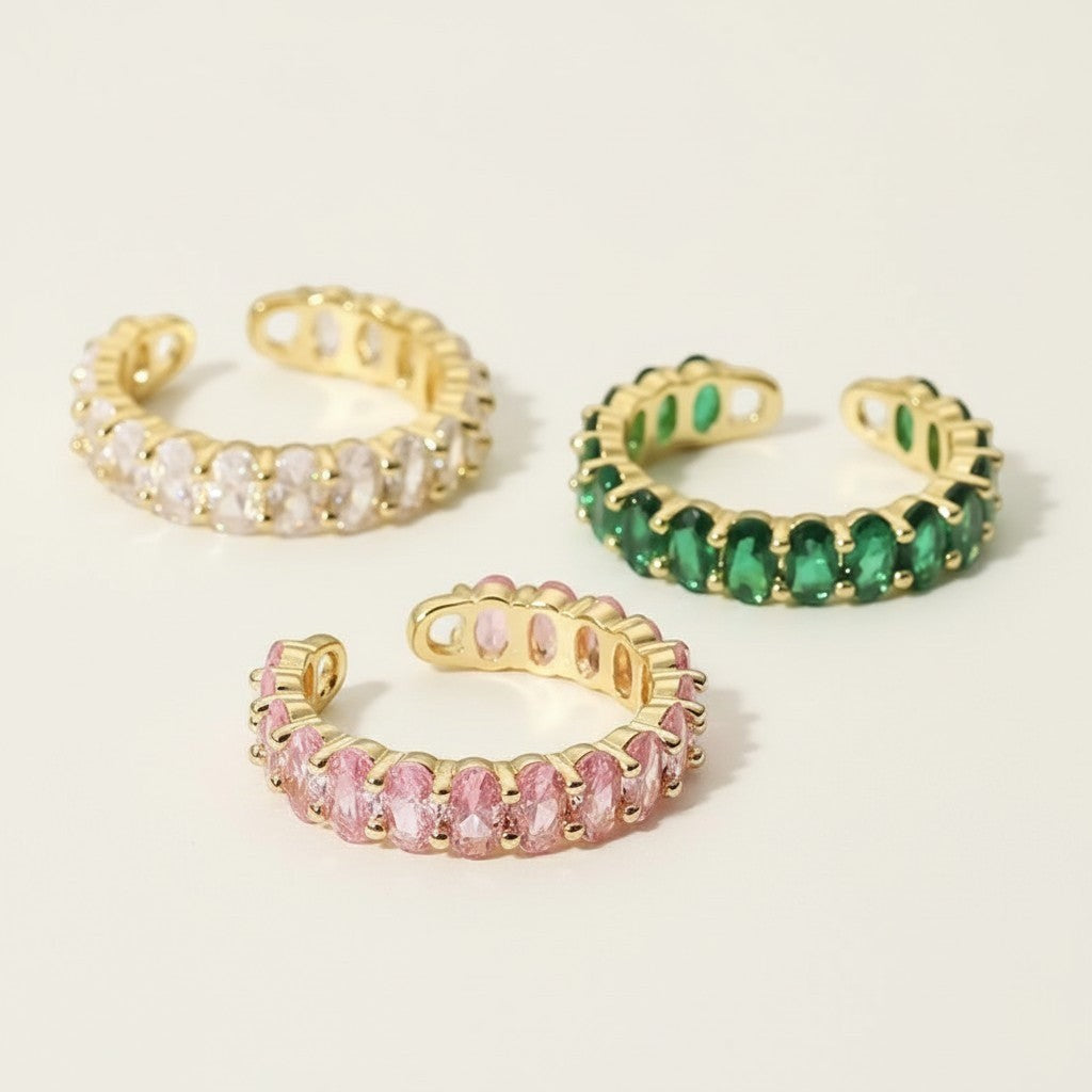 Seraphina Treasures adjustable ring with clear, pink, and green cubic zirconia stones on a gold-tone copper band.