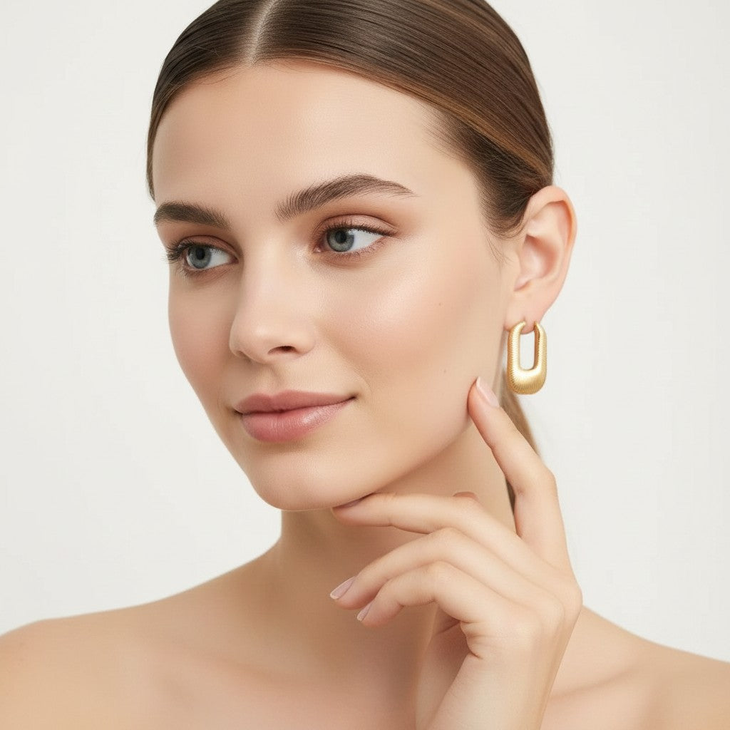 Seraphina Treasures Aelinor gold textured rectangular hoop earrings with smooth curved shape.