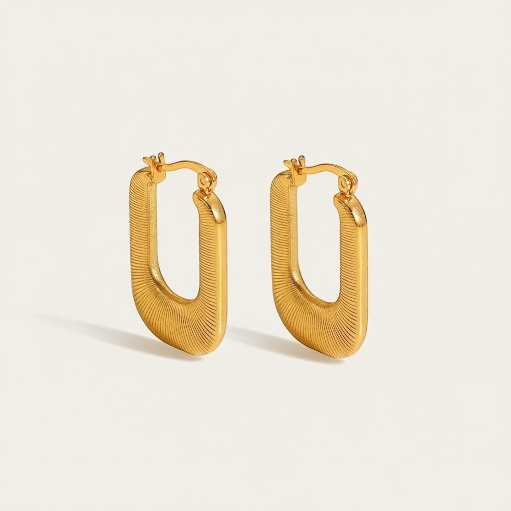 Seraphina Treasures Aelinor gold-tone earrings with a smooth, curved shape and threaded detail.