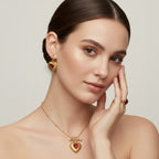 Seraphina Treasures gold heart pendant necklace with red agate and pearl, matching earrings and ring.