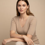 Seraphina Treasures Alara bracelet with a red heart-shaped agate stone on a gold chain, worn by a model.