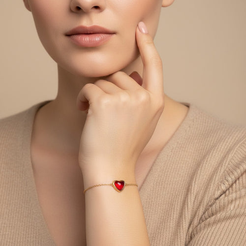 Seraphina Treasures Alara bracelet with a red heart-shaped agate stone on a gold chain. Adjustable clasp.