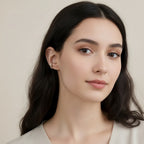 Seraphina Treasures Allegra ear clip, a silver hoop with a gold accent, worn on a woman's ear.