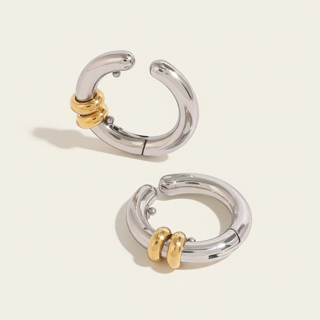 Seraphina Treasures Allegra ear clip in silver tone with gold tone accent rings. Modern geometric design.