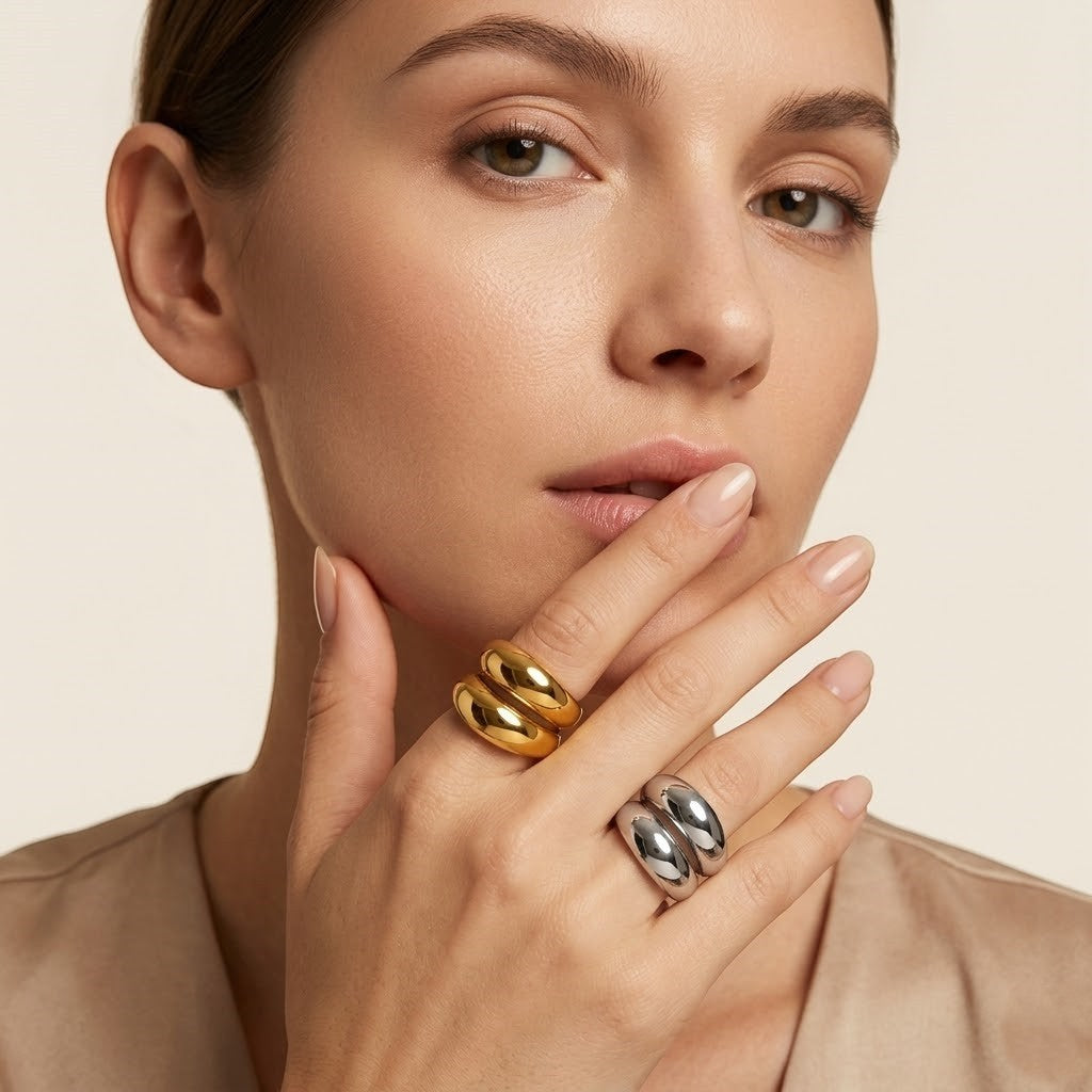 Seraphina Treasures Althea ring in gold and silver, featuring a modern open design with geometric lines on a woman's hand.