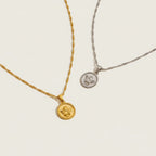 Seraphina Treasures gold and silver Angelure necklaces with delicate chains and round pendants featuring an angel motif.