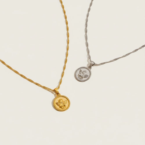 Seraphina Treasures gold and silver Angelure necklaces with delicate chains and round pendants featuring an angel motif.