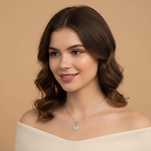 Seraphina Treasures Angelure necklace with a round pendant featuring an angel design and rope-like border. Silver-tone metal.