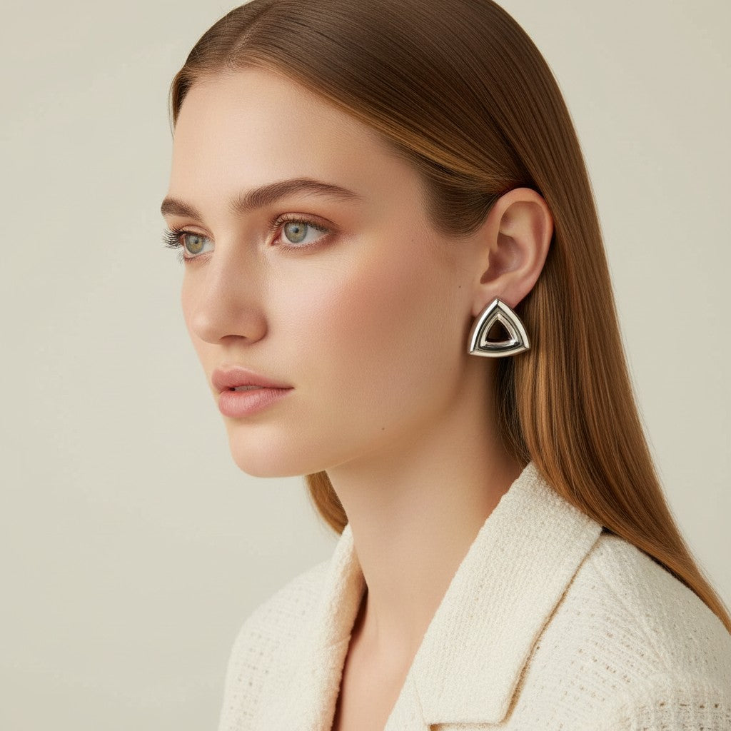 Seraphina Treasures Arcana gold triangle earrings with a hollow center, modern minimalist design.