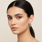 Seraphina Treasures Asteria gold hoop earrings with cut-out star and moon design, accented with cubic zirconia stones.