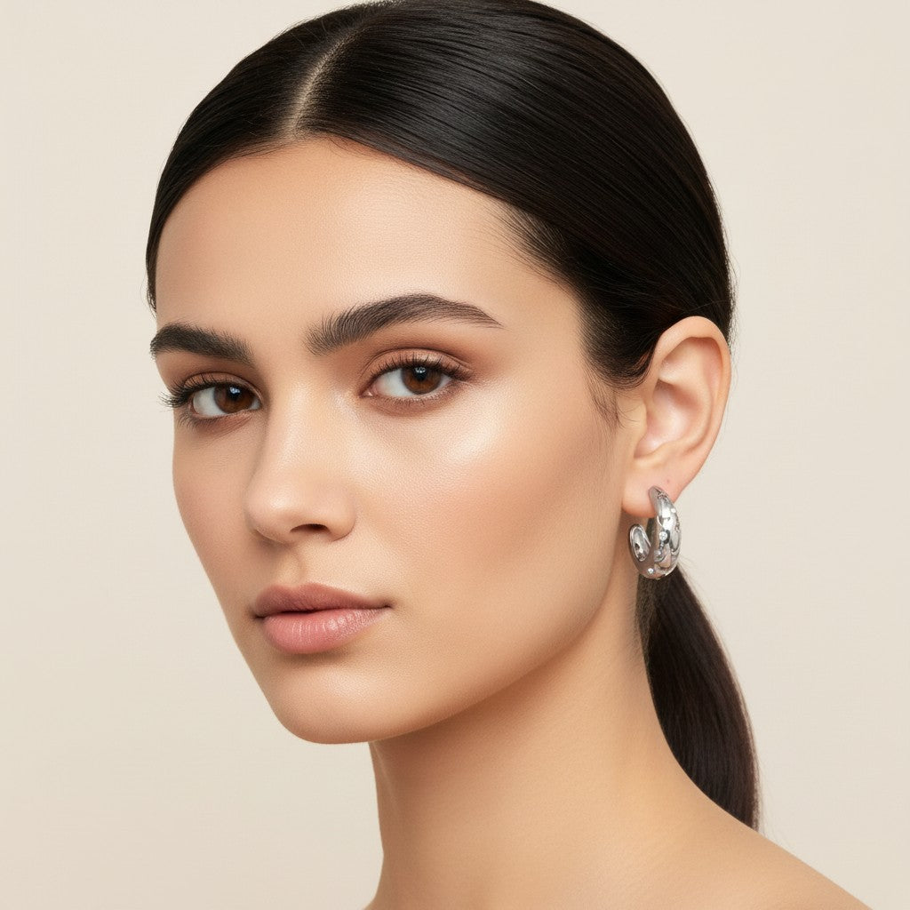 Seraphina Treasures Asteria gold hoop earrings with cut-out star and moon design, accented with cubic zirconia stones.
