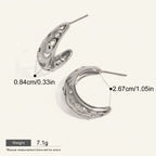 Seraphina Treasures Asteria silver hoop earrings with cut-out stars and moons, adorned with cubic zirconia.