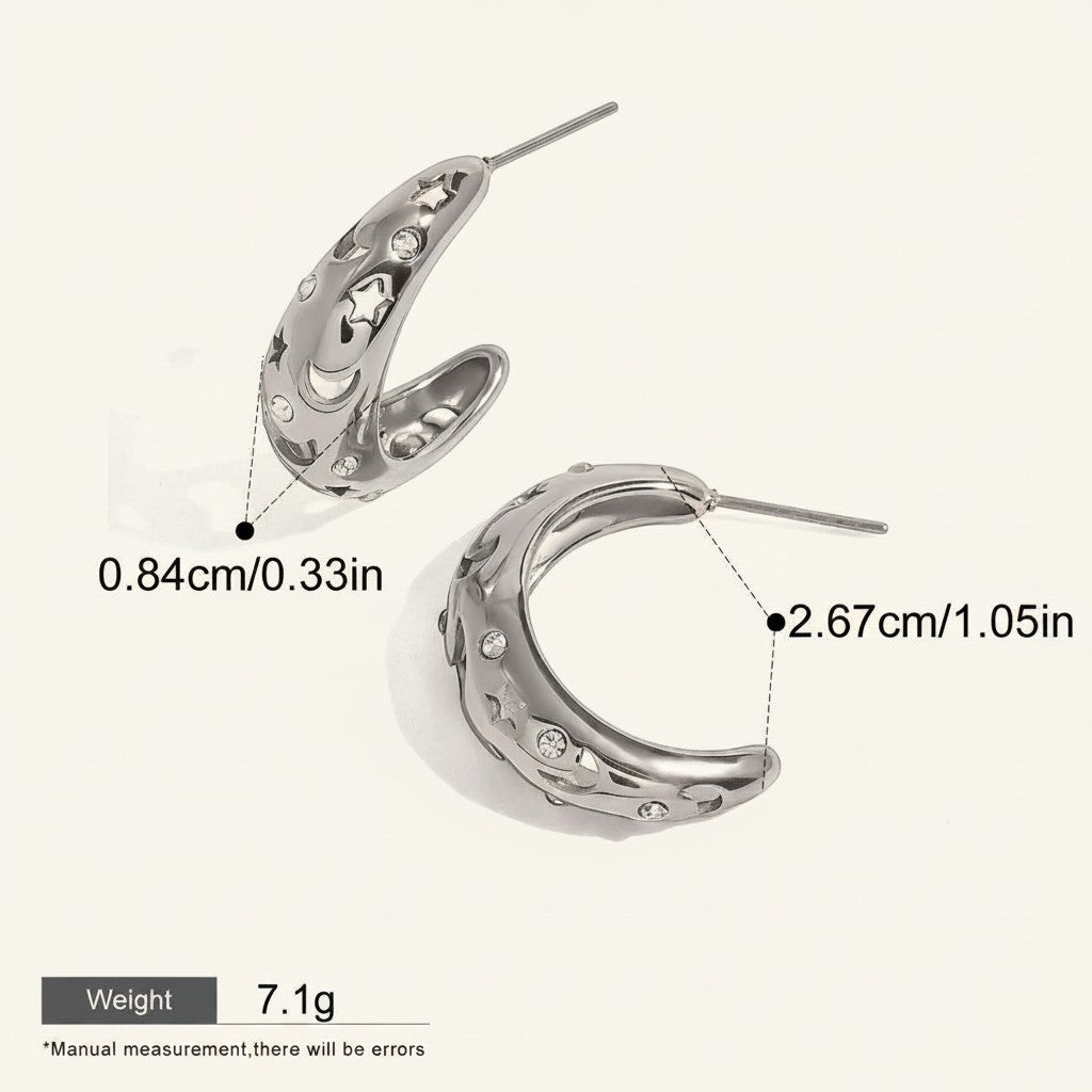 Seraphina Treasures Asteria silver hoop earrings with cut-out stars and moons, adorned with cubic zirconia.
