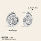 Seraphina Treasures Aurelia silver spiral shell stud earrings. Unique design, lightweight, and hypoallergenic.