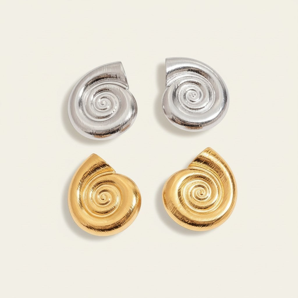 Seraphina Treasures Aurelia gold and silver spiral shell earrings with textured finish.