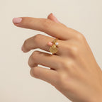 Seraphina Treasures Aurelis gold ring with coral, pearl, and shell charms. Adjustable band.