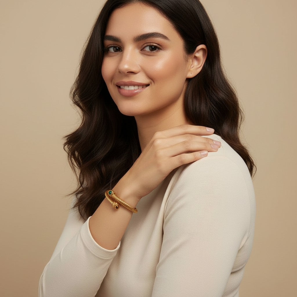 Seraphina Treasures Aureth gold ribbed cuff bracelet with green and brown stone accents.