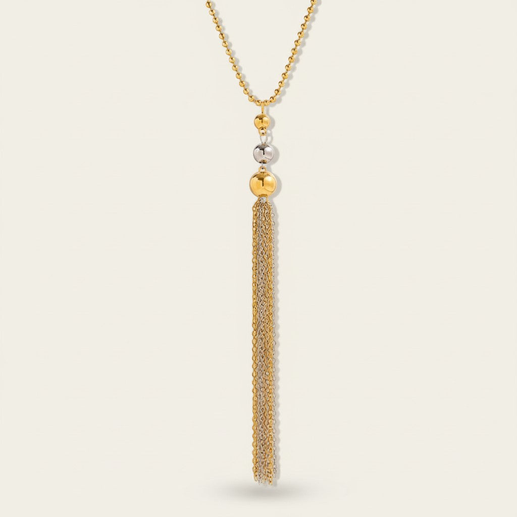 Seraphina Treasures Bastet necklace with gold and silver bead accents and a long, multi-strand tassel.