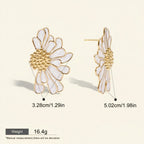 Seraphina Treasures Cassiania white enamel daisy stud earrings with gold accents.