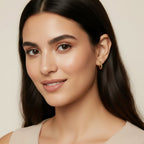 Seraphina Treasures Cassira gold twist hoop earrings on a model.