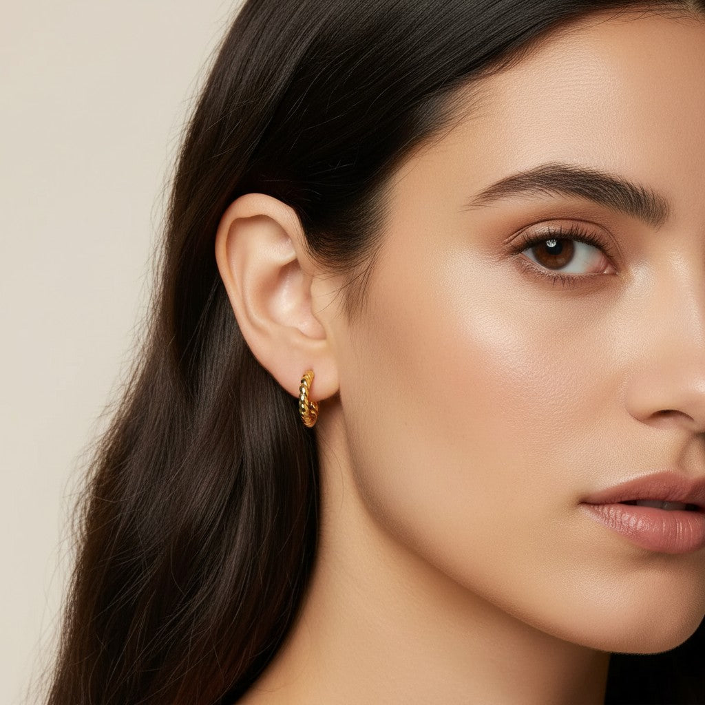 Seraphina Treasures Cassira gold twisted hoop earrings on ear.