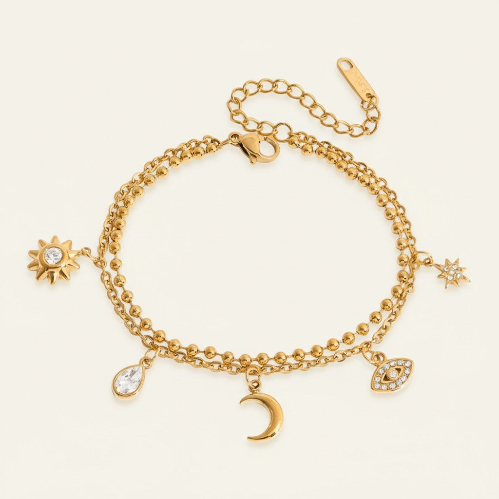 Seraphina Treasures gold-tone bracelet with sun, moon, star, water drop, and evil eye charms.