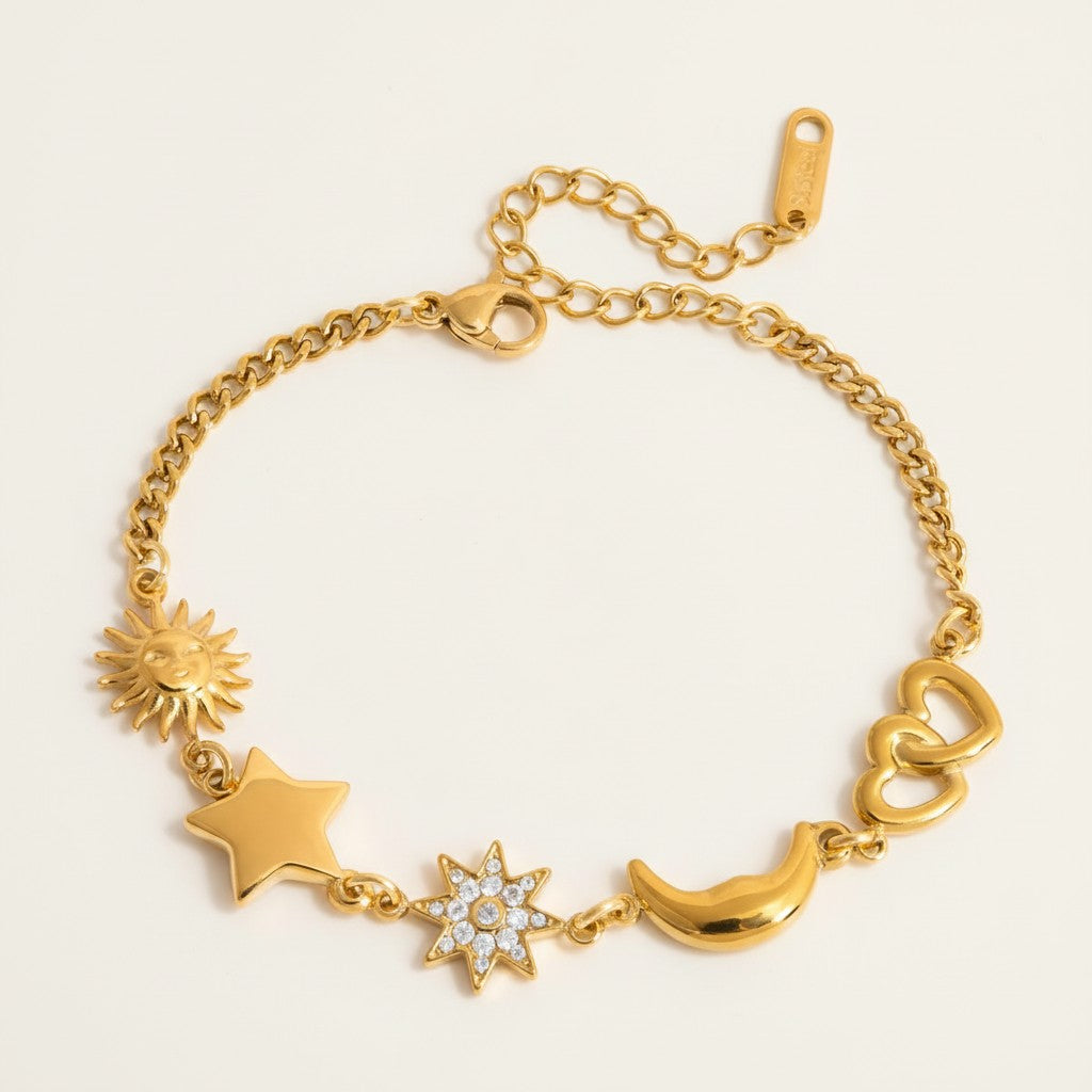 Seraphina Treasures gold-tone bracelet with sun, star, crystal star, moon, and double heart charms. Adjustable.