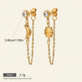 Seraphina Treasures gold celestial drop earrings with moon and sun charms, featuring clear crystal studs and delicate chains.