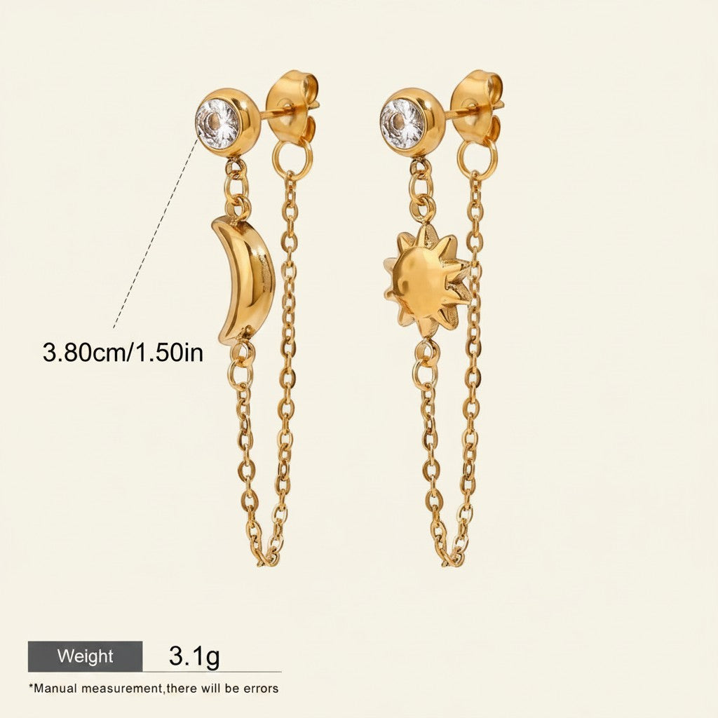 Seraphina Treasures gold celestial drop earrings with moon and sun charms, featuring clear crystal studs and delicate chains.