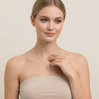 Seraphina Treasures gold necklace with a cherry pendant adorned with pink zirconia stones.