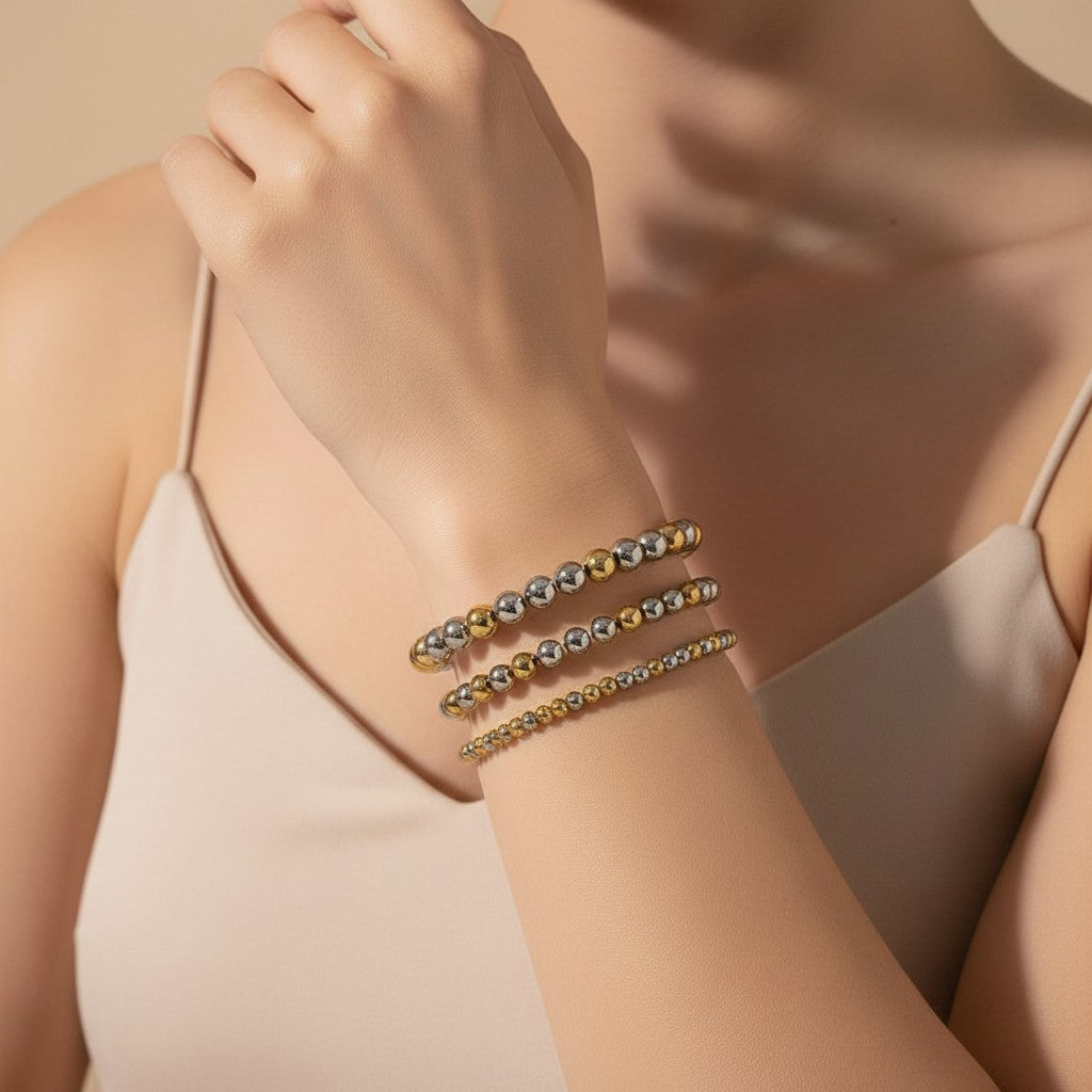 Seraphina Treasures Clio bracelet set with gold and silver stainless steel beads. Elastic, flexible fit, perfect for layering.