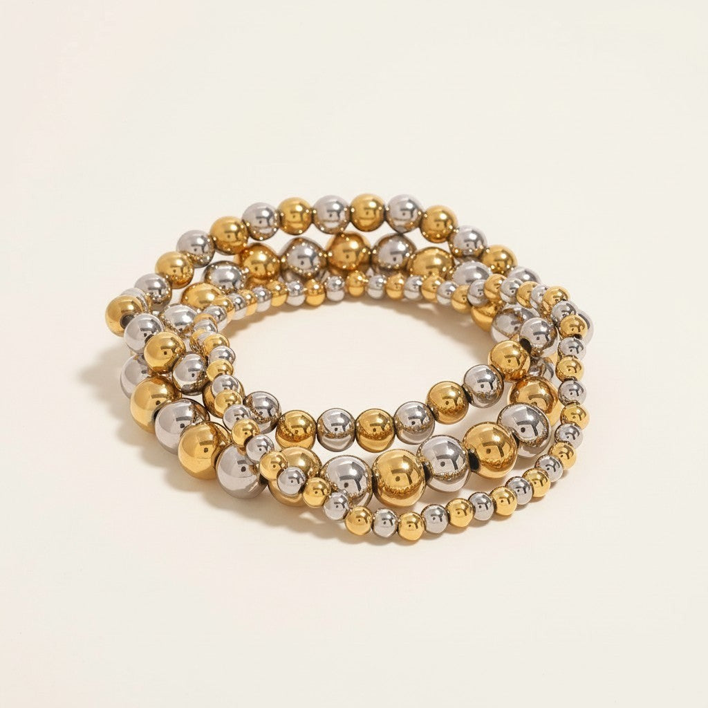 Seraphina Treasures Clio bracelet set with gold and silver stainless steel beads. Elastic, flexible fit.