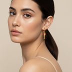 Seraphina Treasures Corinnae gold hoop earrings with fish charm and coral beads.