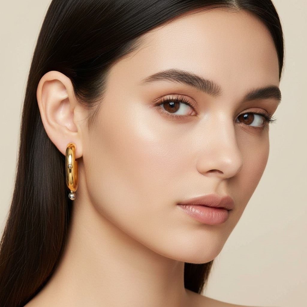 Seraphina Treasures Corvella gold hoop earrings with silver bead accents. Waterproof and hypoallergenic.