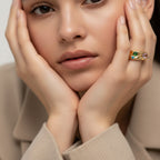 Seraphina Treasures Corvian ring with a pink oval gemstone and small green and blue accent stones on a gold band.