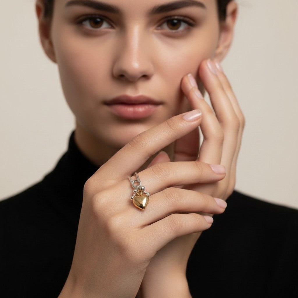 Seraphina Treasures Cressida ring with a double-layer silver band and a gold heart pendant.