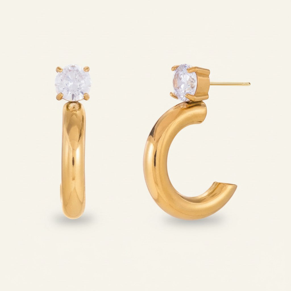 Seraphina Treasures Damaris gold C-shaped hoop earrings with clear zircon stones.