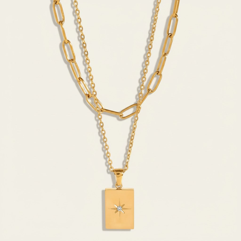 Seraphina Treasures Daphne layered gold necklace with rectangular pendant featuring a starburst cubic zirconia.