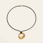 Seraphina Treasures Deirdre gold irregular pendant necklace on black wax rope with gold bead accents.