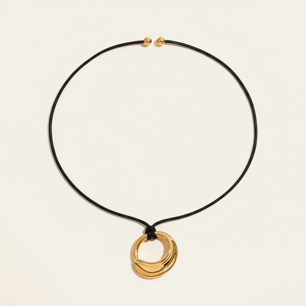 Seraphina Treasures Deirdre gold irregular pendant necklace on black wax rope with gold bead accents.
