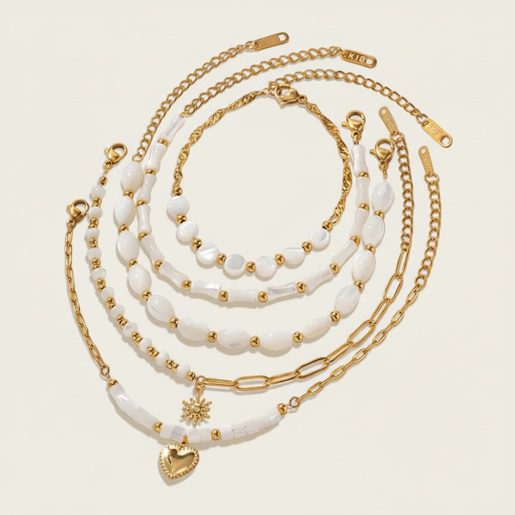 Seraphina Treasures Delia bracelet set with white shells and gold beads, featuring heart and sun charms.