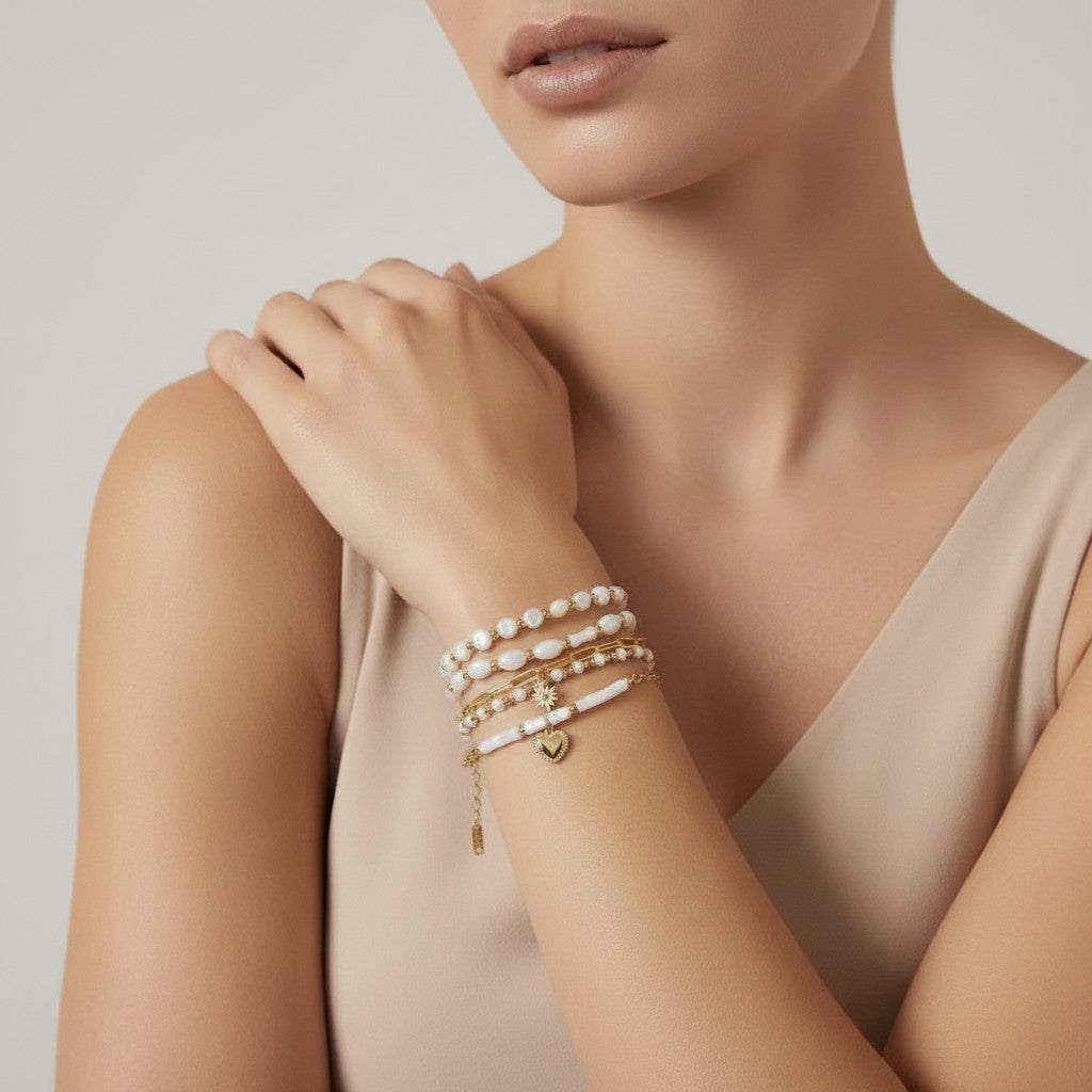 Seraphina Treasures Delia bracelet set with white shell beads, gold accents, and a heart charm.