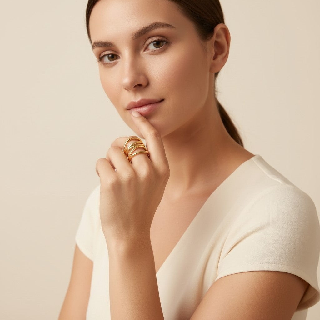 Seraphina Treasures Drusilla gold ring with layered, skeleton-inspired design on a woman's finger.