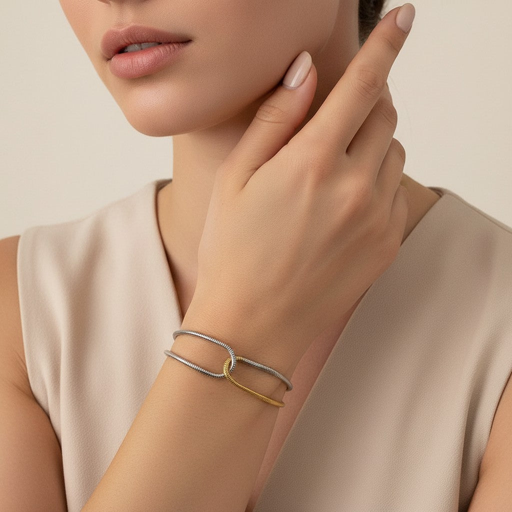 Seraphina Treasures Eirian dual-tone snake chain bracelet with a knot detail. Silver and gold metal.