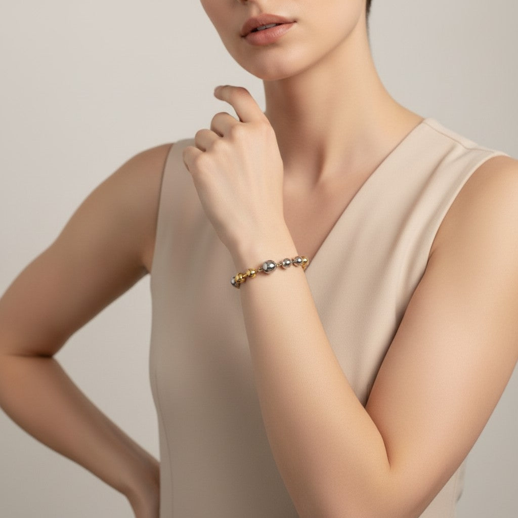Seraphina Treasures Elara bracelet with alternating gold and silver spheres on a woman's wrist.
