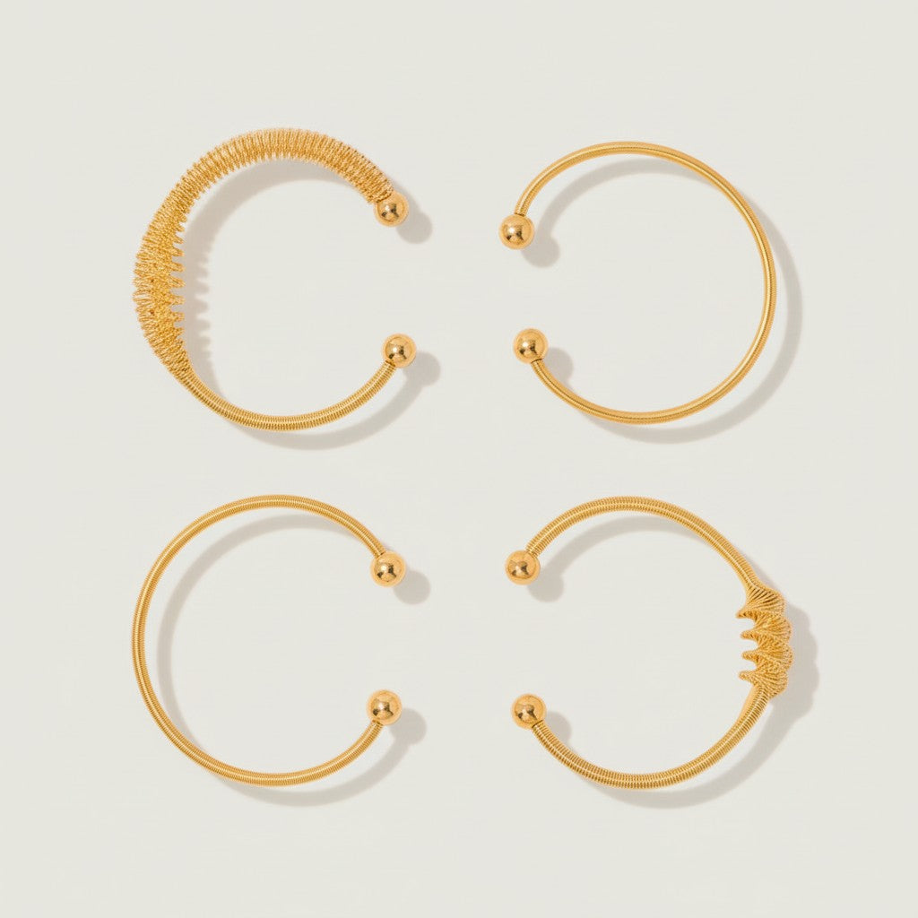 Seraphina Treasures Elaria gold-tone metal bracelets with polished ball ends and intricate wire designs.