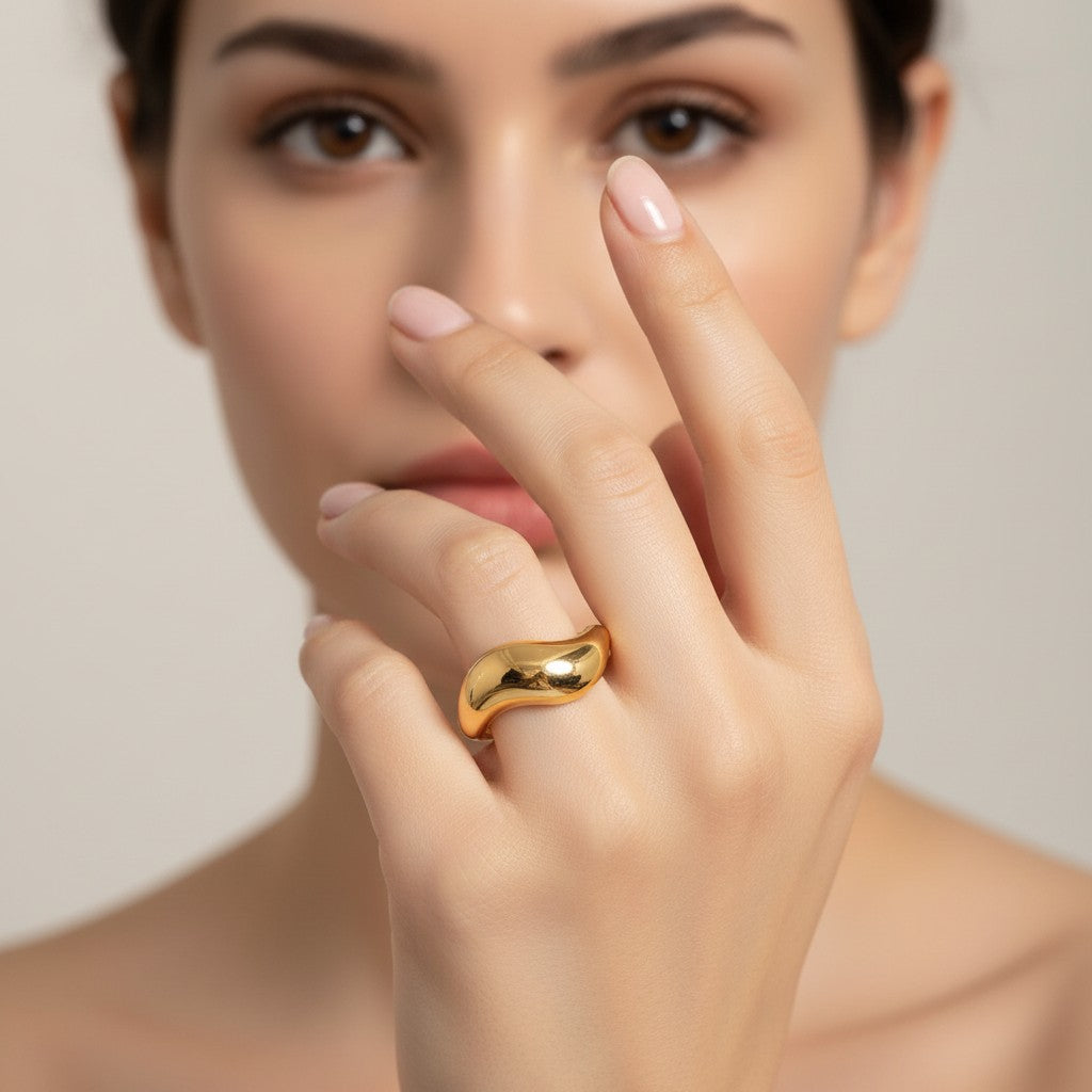 Seraphina Treasures Electra Ring in gold and silver, featuring a unique flowing wave design. Modern statement ring.