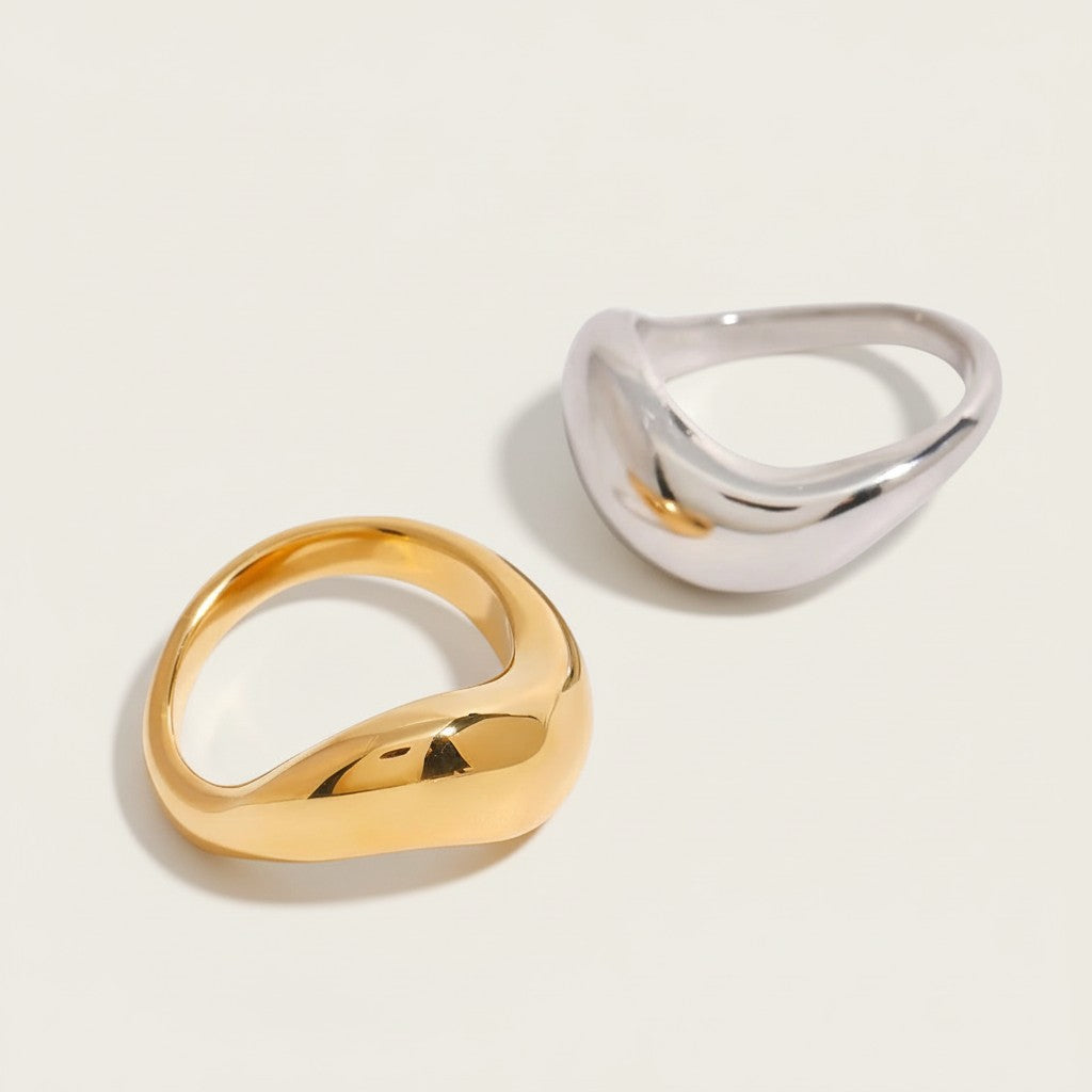Seraphina Treasures Electra Ring in gold and silver, featuring a flowing irregular wave design.