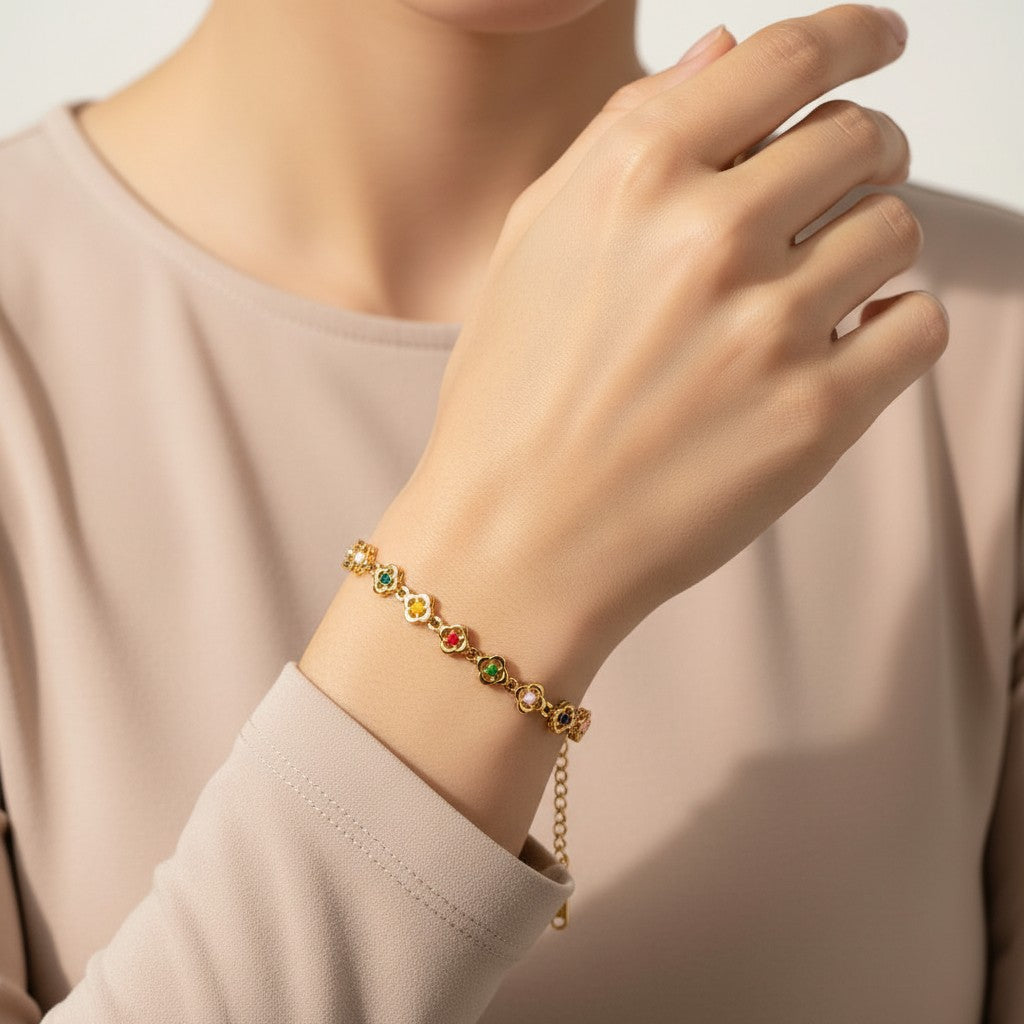 Seraphina Treasures Elpis gold-tone bracelet with colorful flower-shaped charms and adjustable clasp.